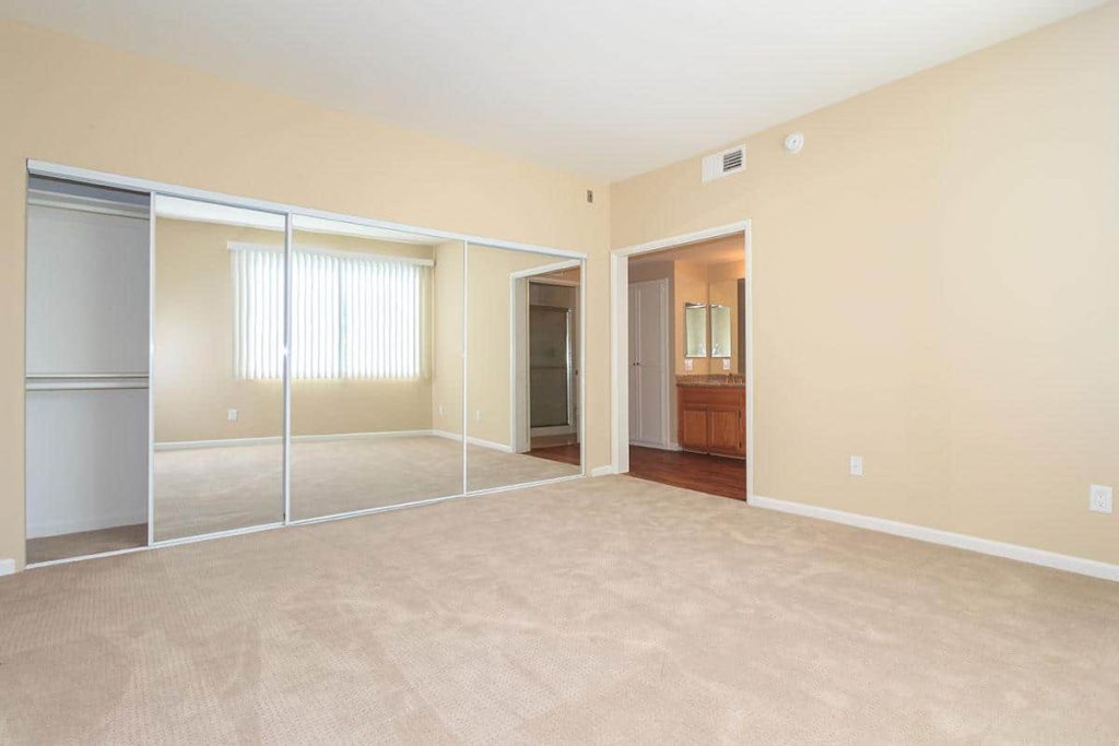 Apartments in Toluca Lake A beige bedroom with closets and mirrors is available in Toluca Lake apartments for rent.