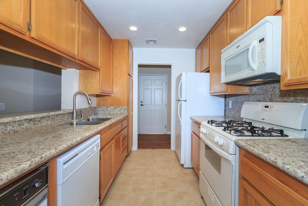 Apartments in Toluca Lake A kitchen with a stove, microwave, and refrigerator in apartments for rent in Toluca Lake.
