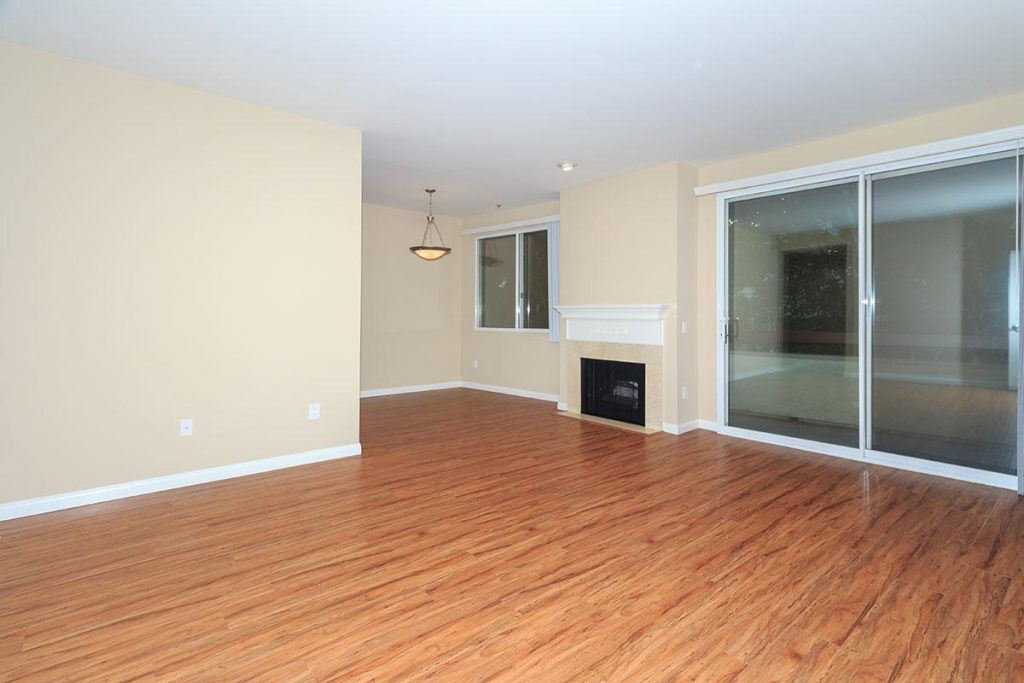 Apartments in Toluca Lake A spacious living room with gleaming hardwood floors and convenient sliding glass doors. Perfect for those in search of apartments in Toluca Lake or apartments for rent in Toluca Lake.