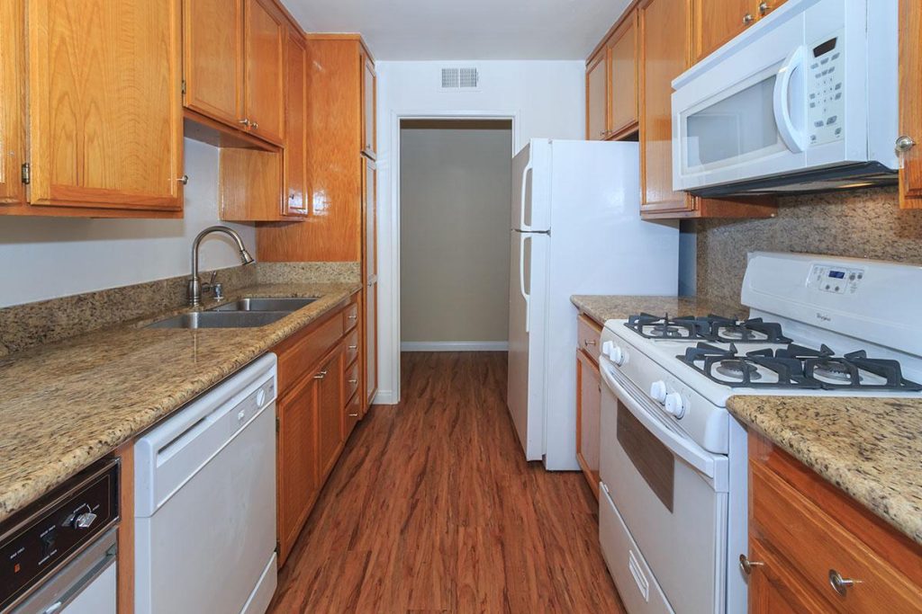 Apartments in Toluca Lake Apartments for rent in Toluca Lake featuring a kitchen with wooden cabinets and a stove.